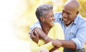 Couple smiling and hugging outside