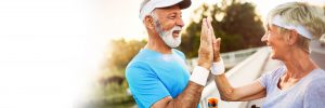 Athletic older couple giving a high five