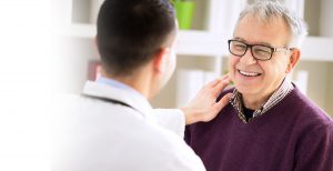 Patient smiling at doctor while being examined